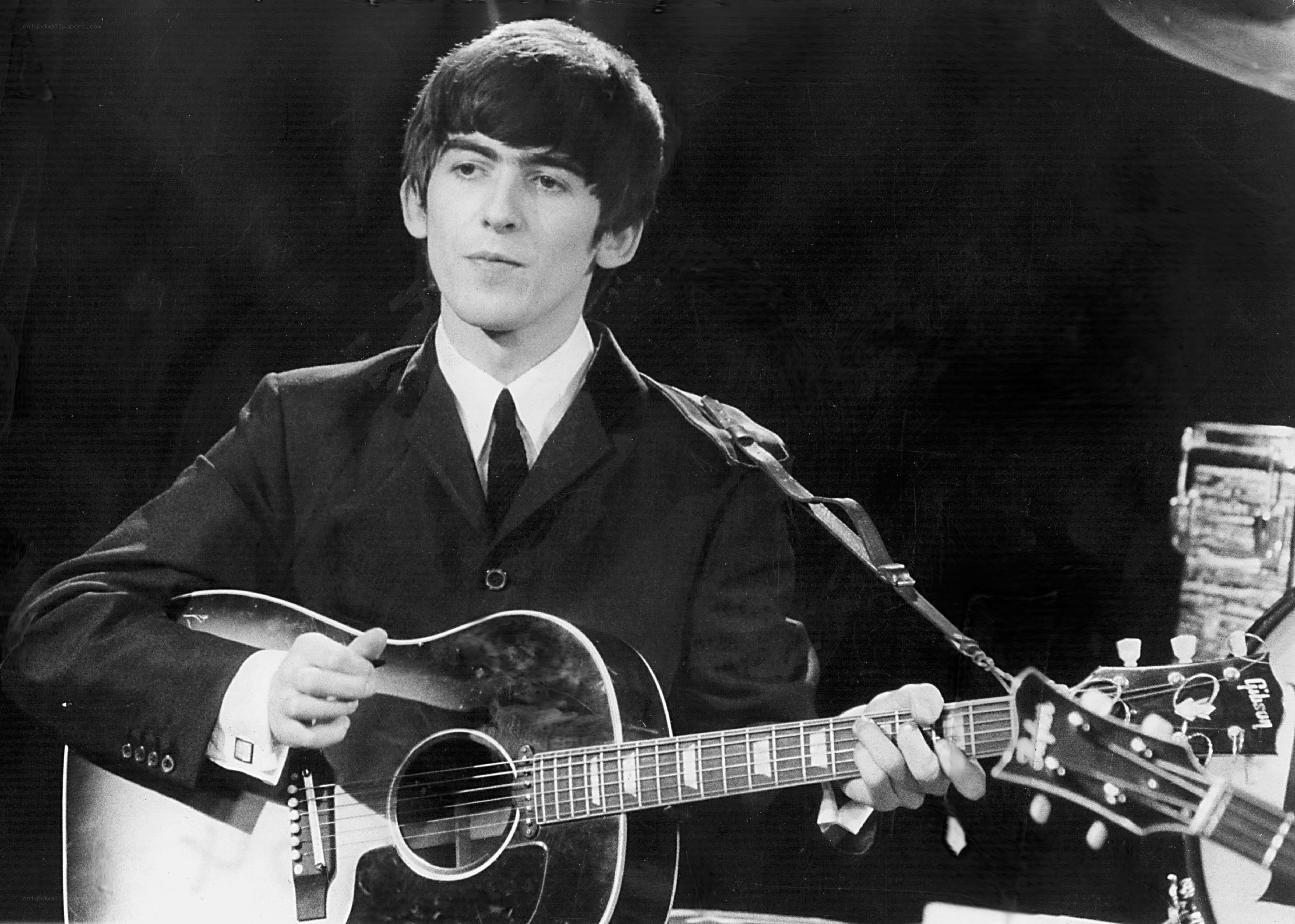 Beatles member playing guitar