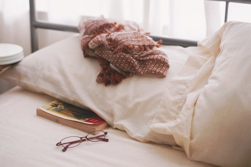 bed with book and glasses