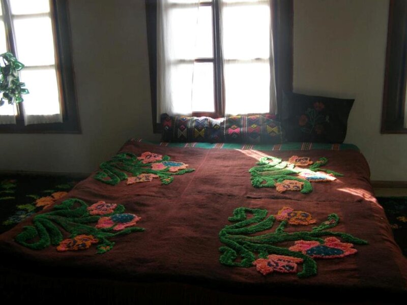 Bed with Embroidered Blanket