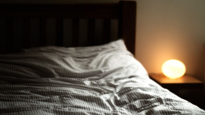 bed with lamp at night
