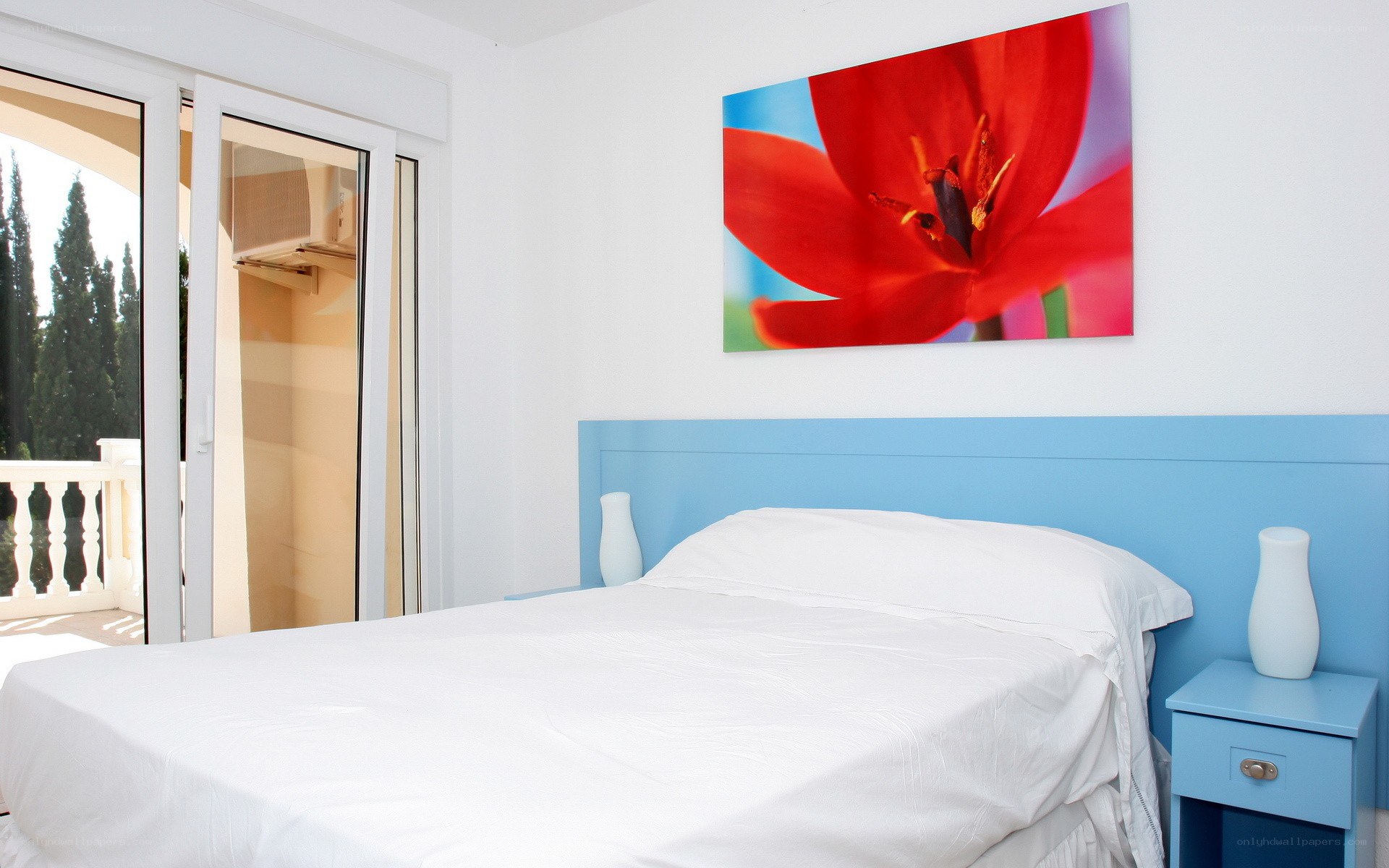 Bedroom with red flower art
