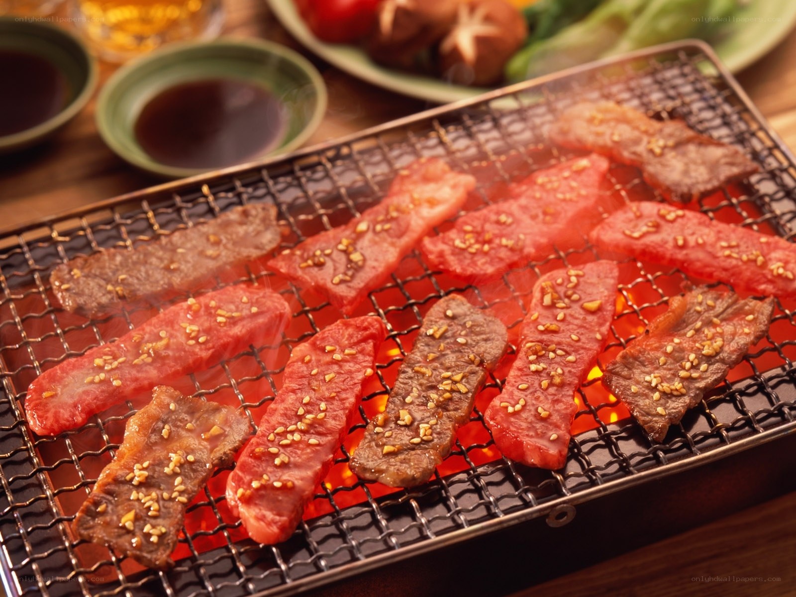 Beef being grilled on a tabletop grill