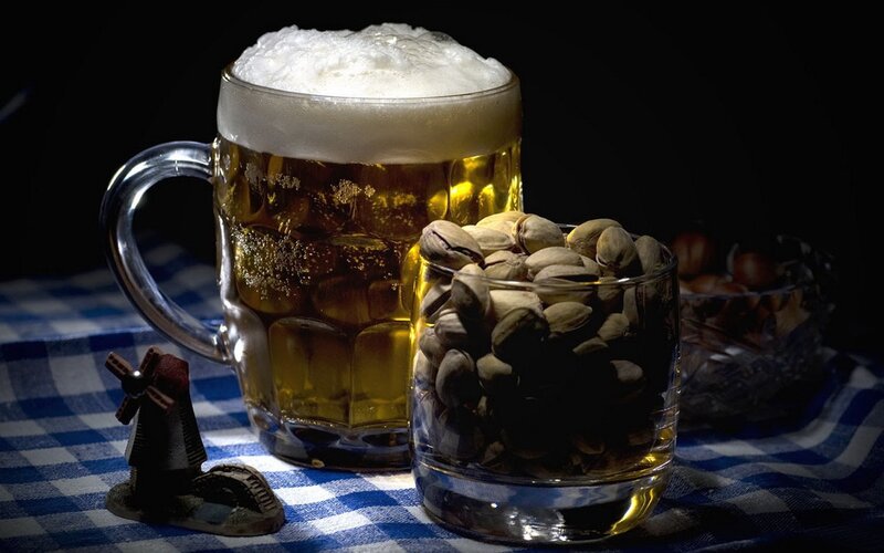 Beer and pistachios on checkered cloth