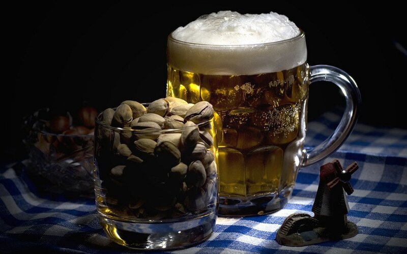 Beer and pistachios on checkered cloth