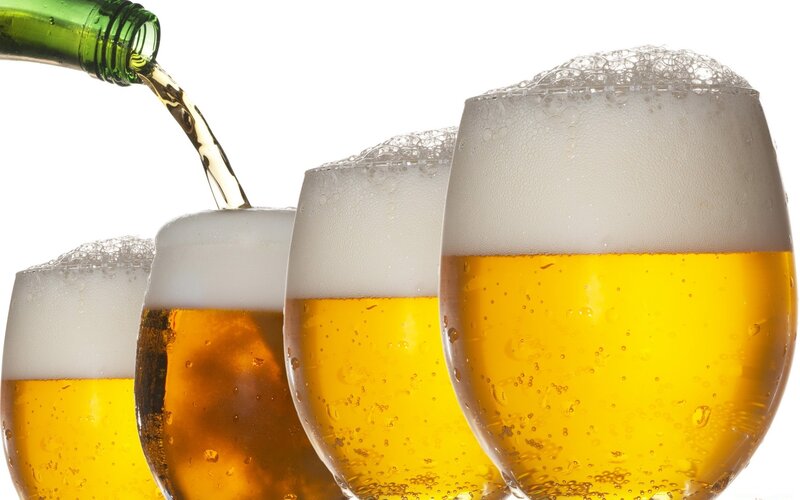 Beer Being Poured into Glasses
