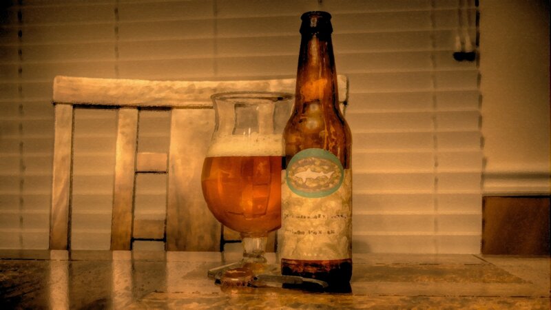 Beer bottle and glass on table
