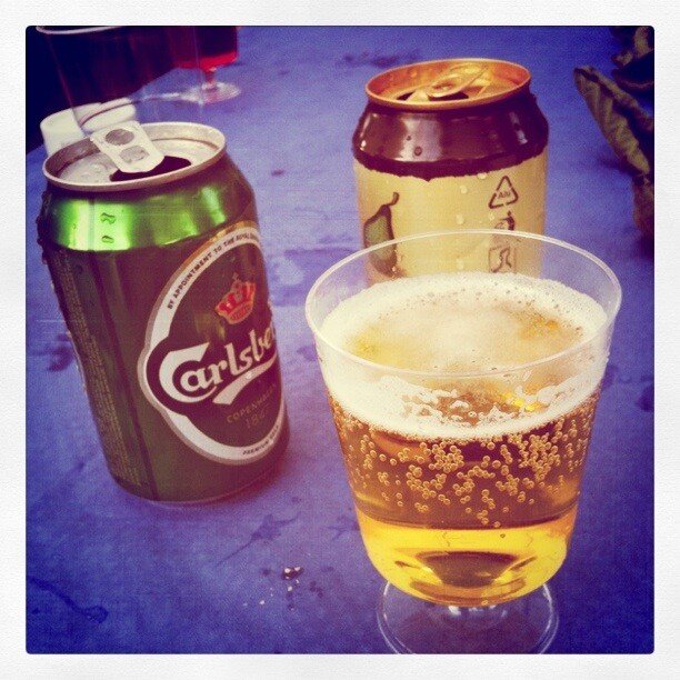beer cans and glass on table