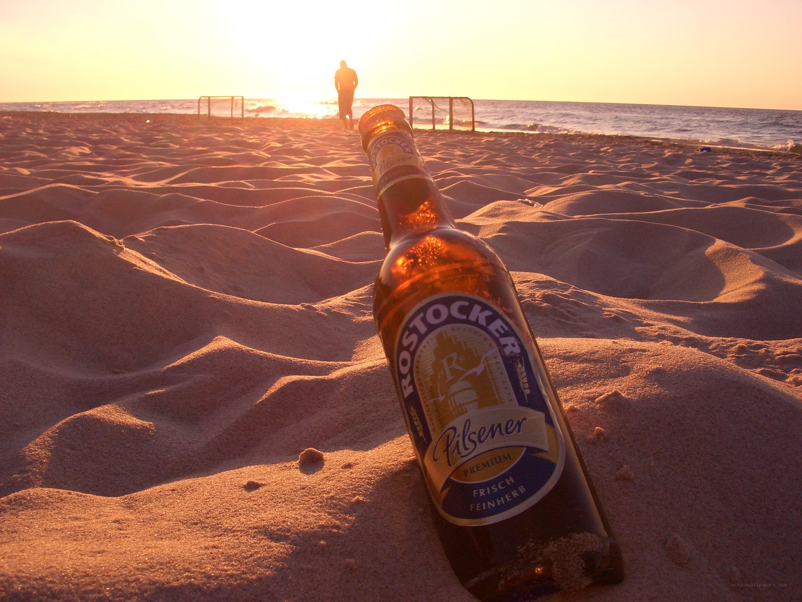 Beer on the beach at sunset