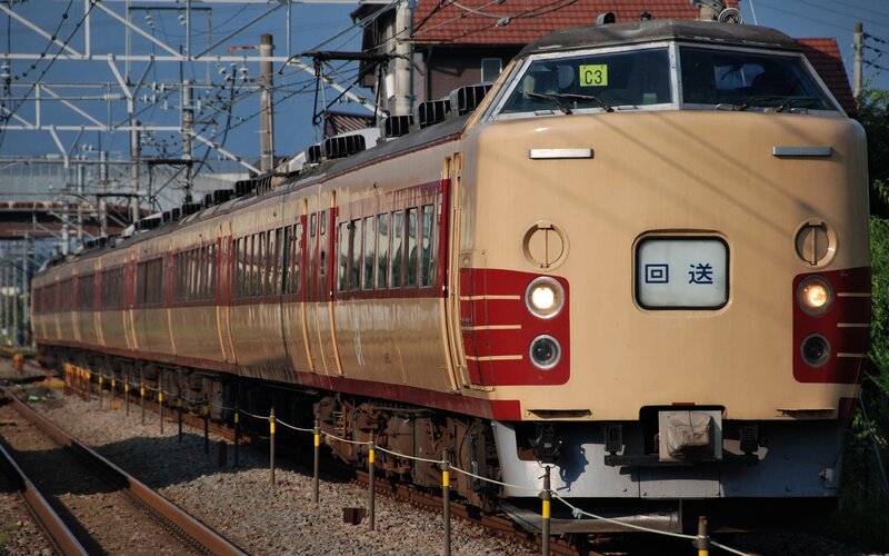 Beige and red train on tracks
