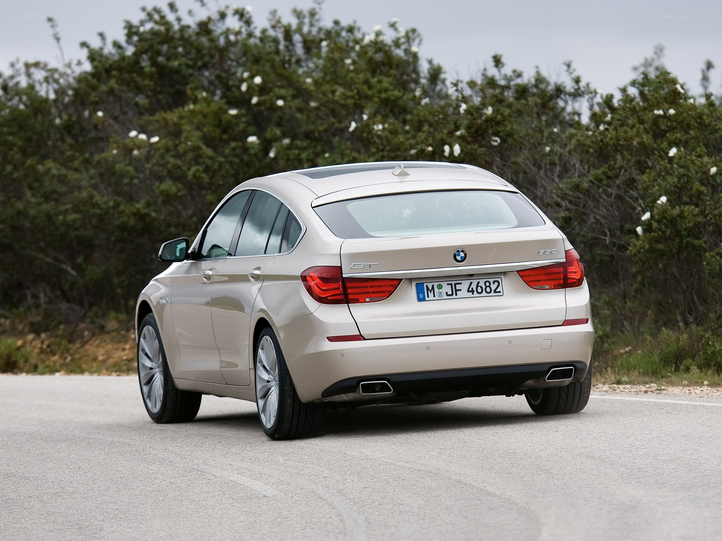 beige bmw gt on road