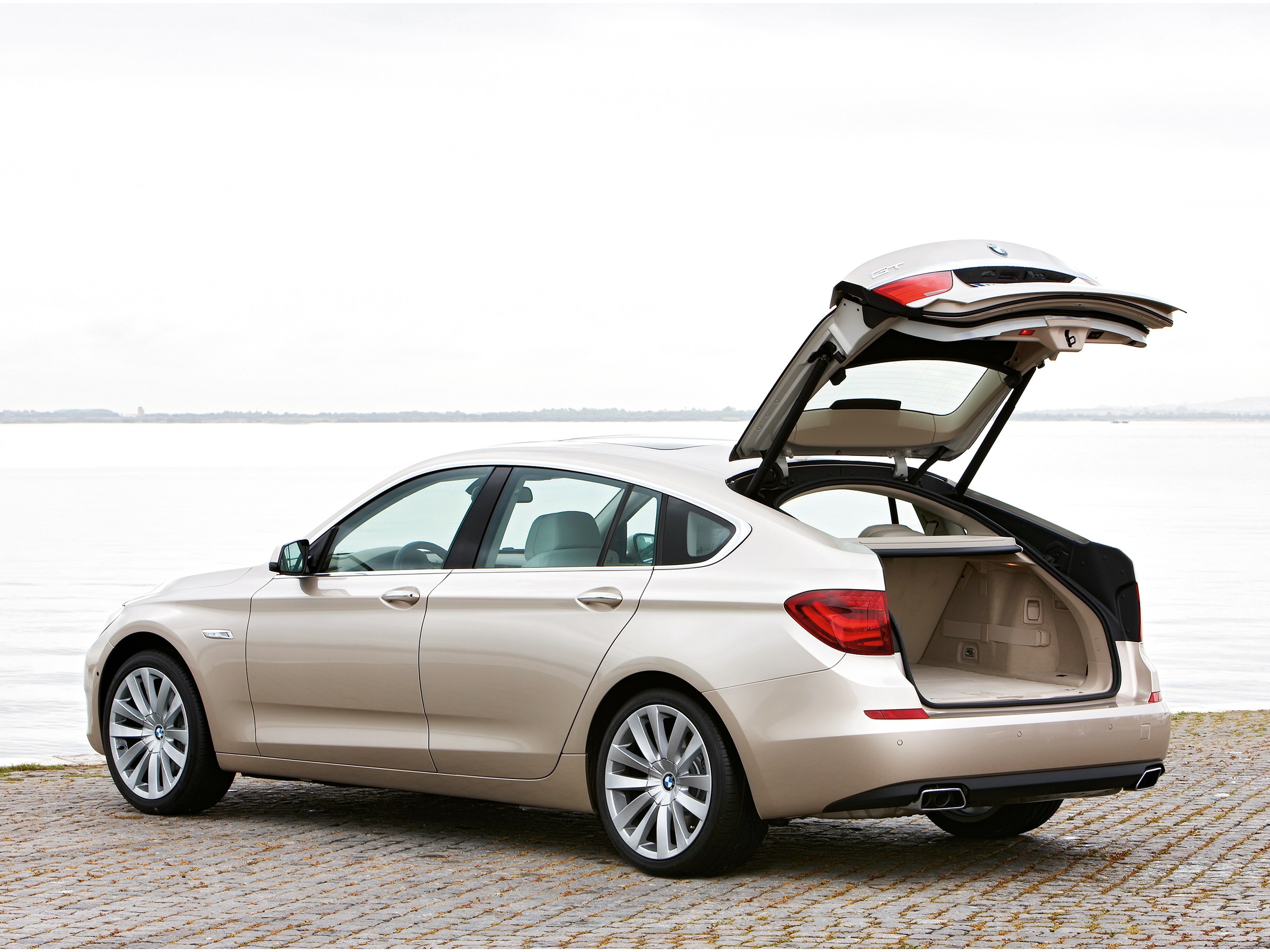 Beige BMW GT with open trunk