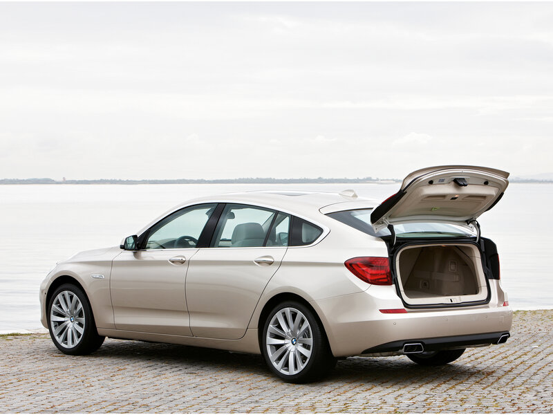 Beige BMW with open trunk