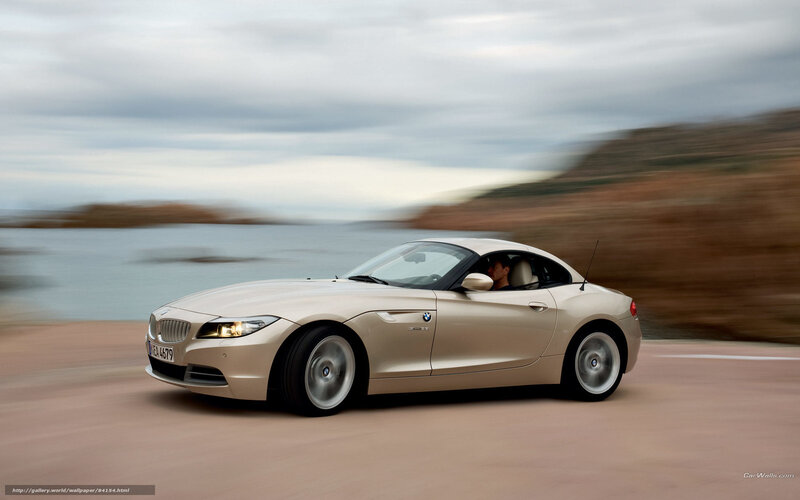 Beige BMW Z4 driving on coastal road