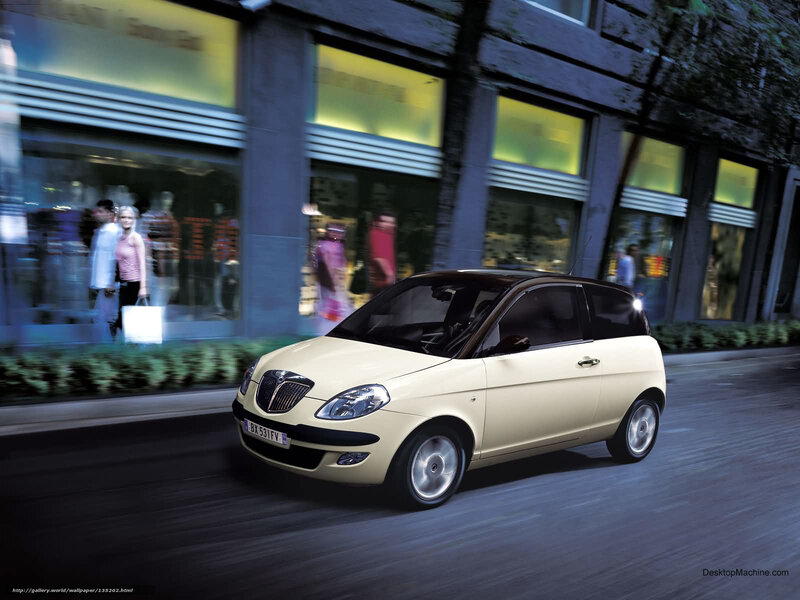Beige car driving in city