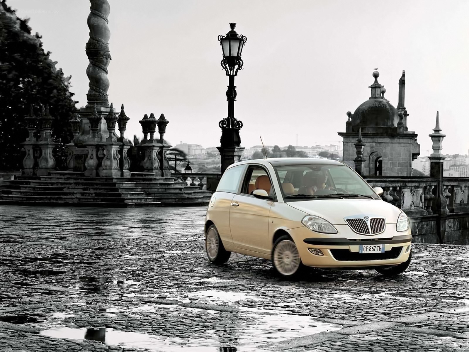 Beige car on cobblestone street