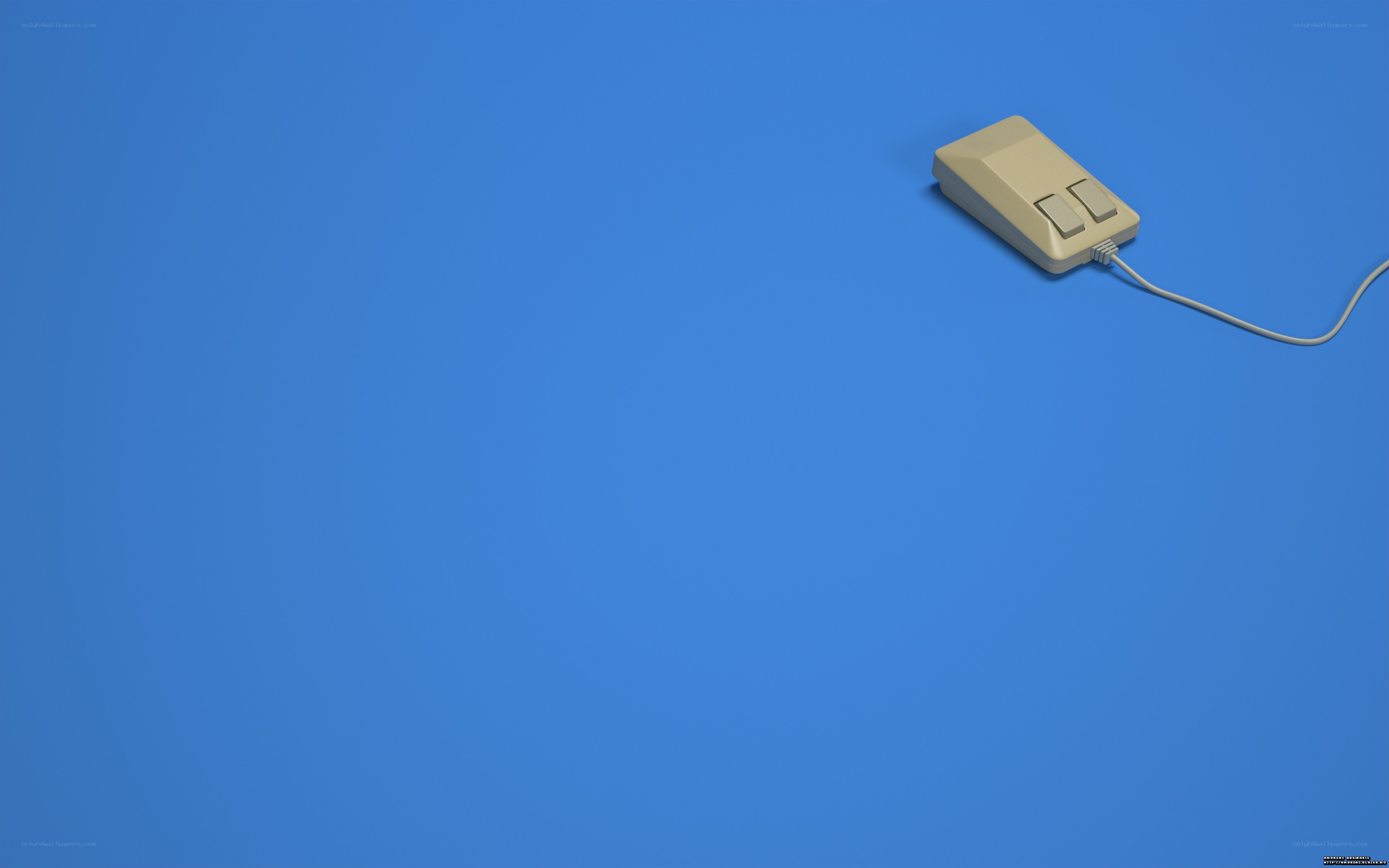 beige computer mouse on blue
