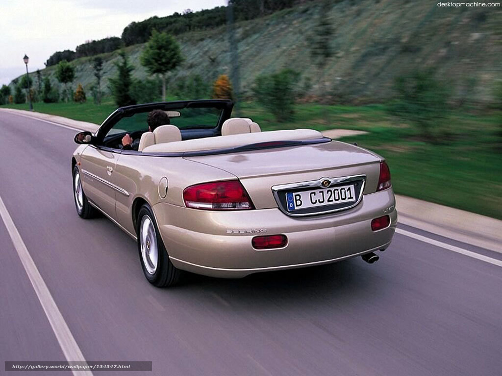 beige convertible driving on road