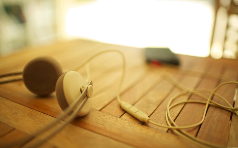 Beige Earphones on Table