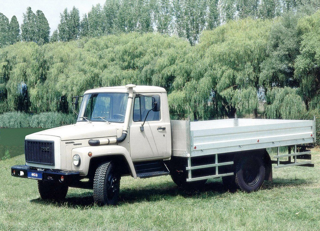 beige flatbed truck in field