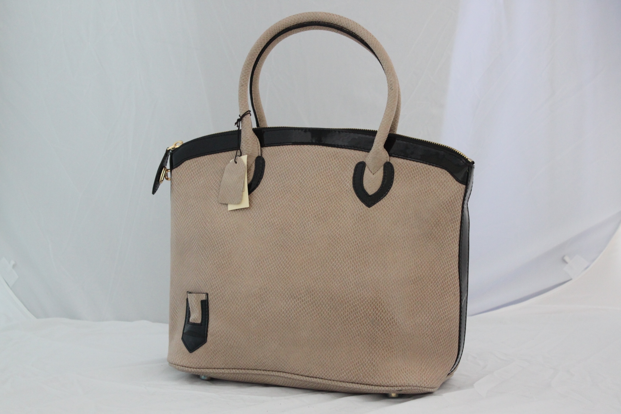 beige handbag with black trim