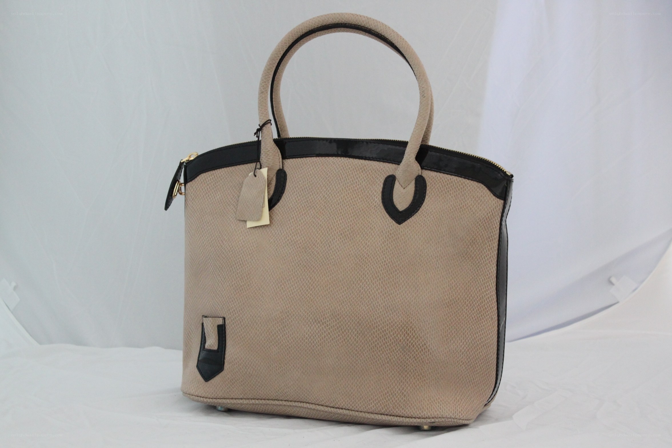 beige handbag with black trim