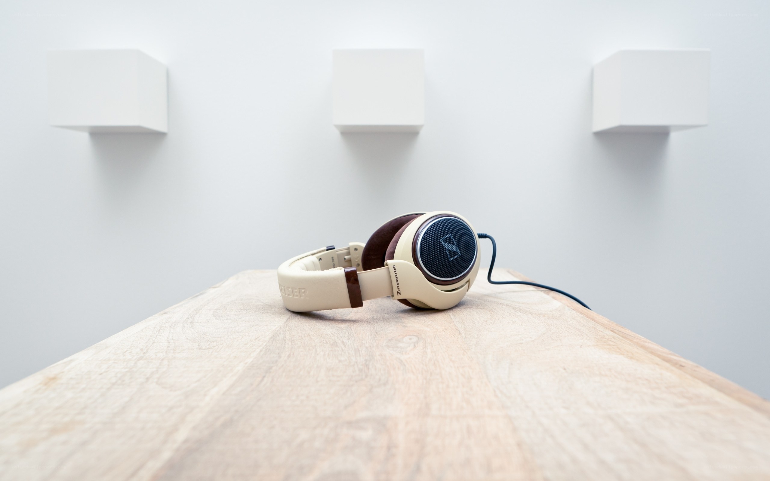 Beige headphones on wooden table