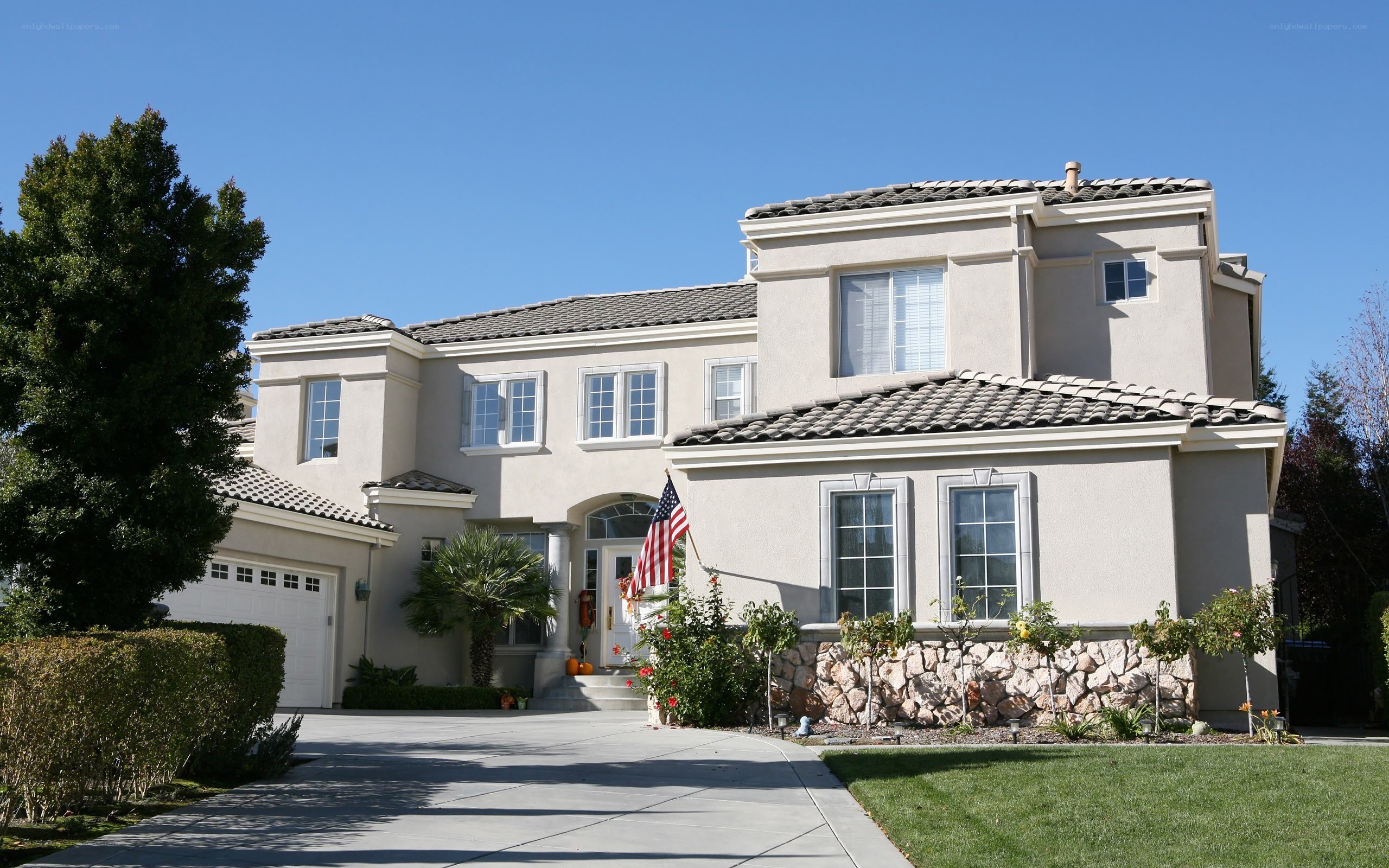beige house with American flag