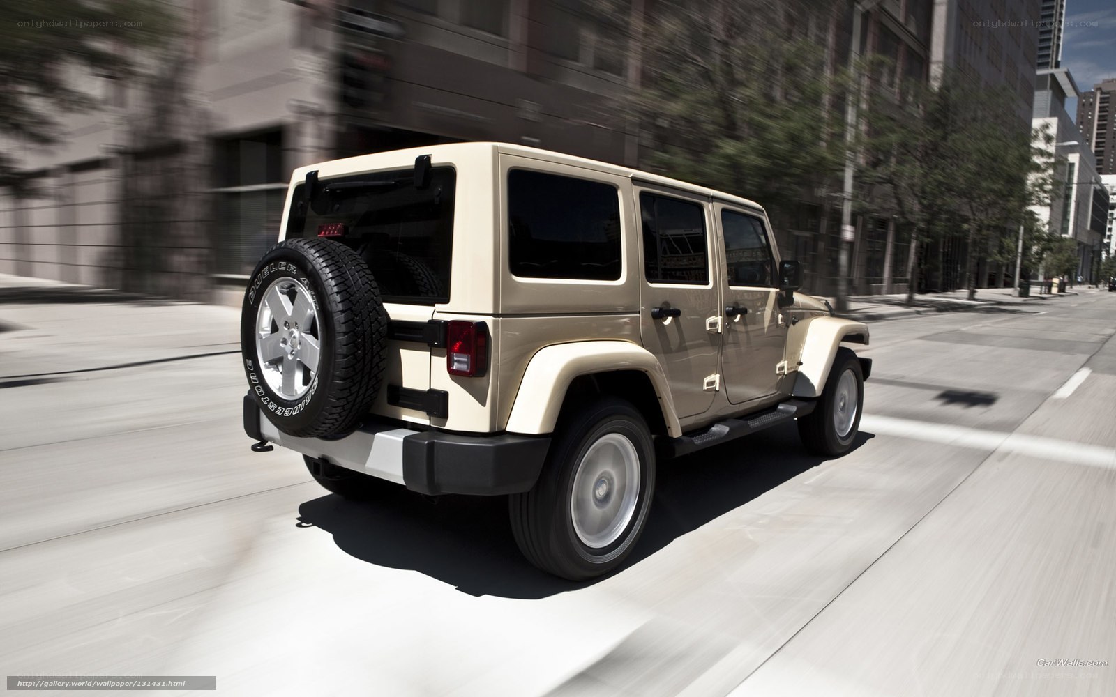 Beige Jeep Wrangler in motion