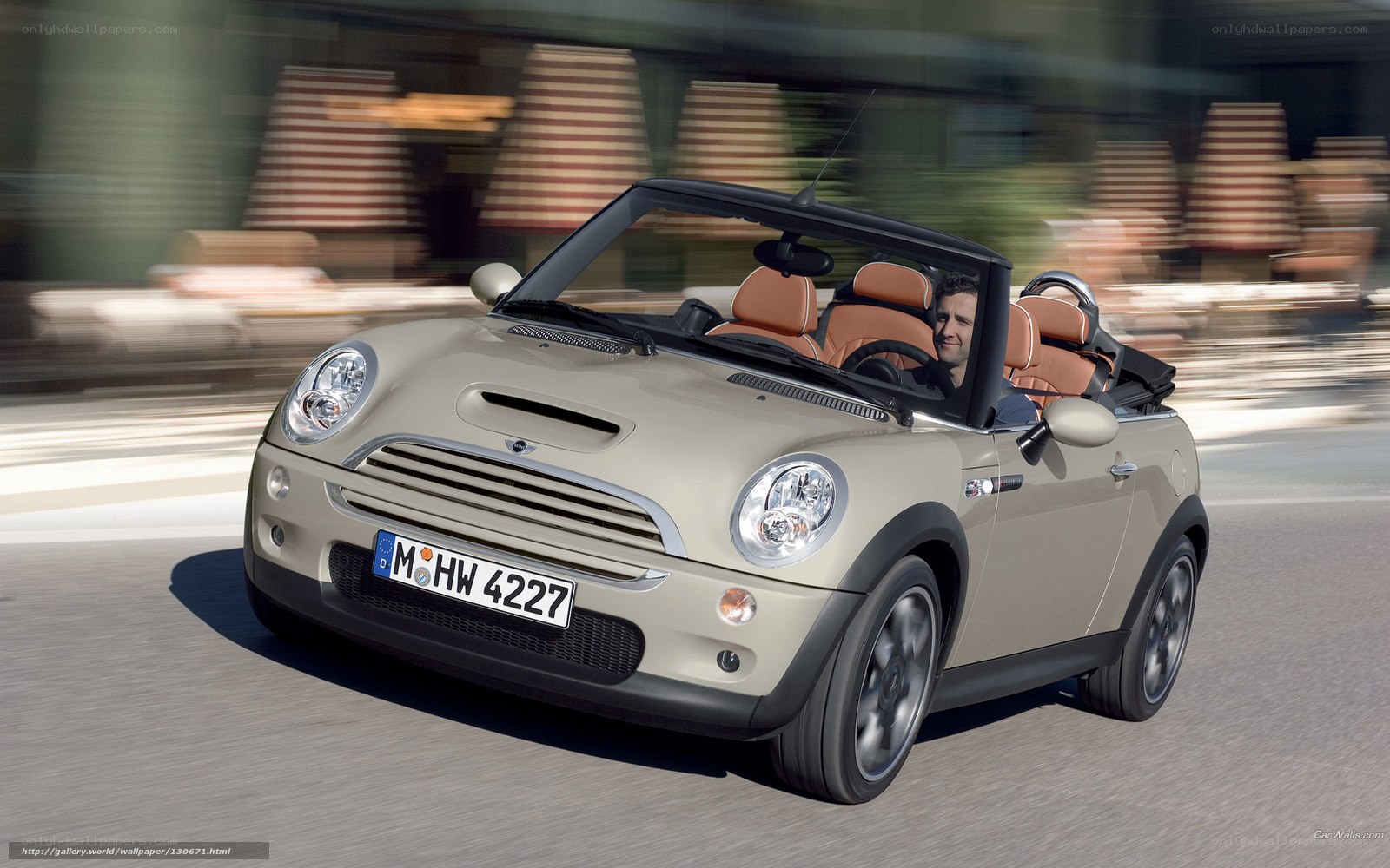 Beige MINI Cooper convertible driving