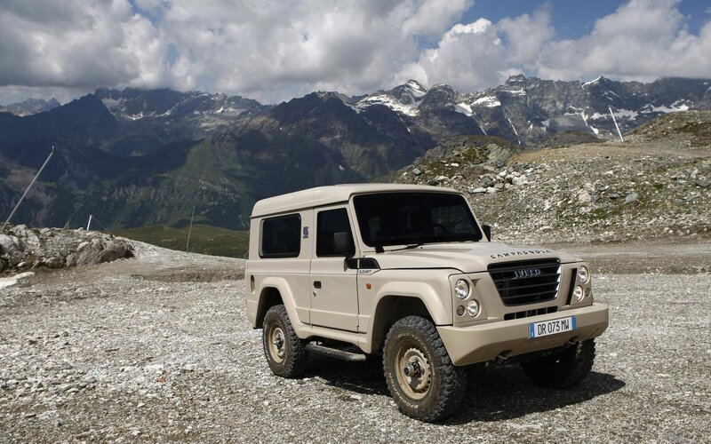 Beige off-road vehicle in mountains