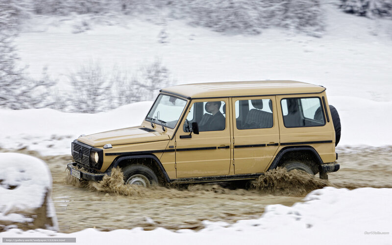 Beige SUV driving through mud