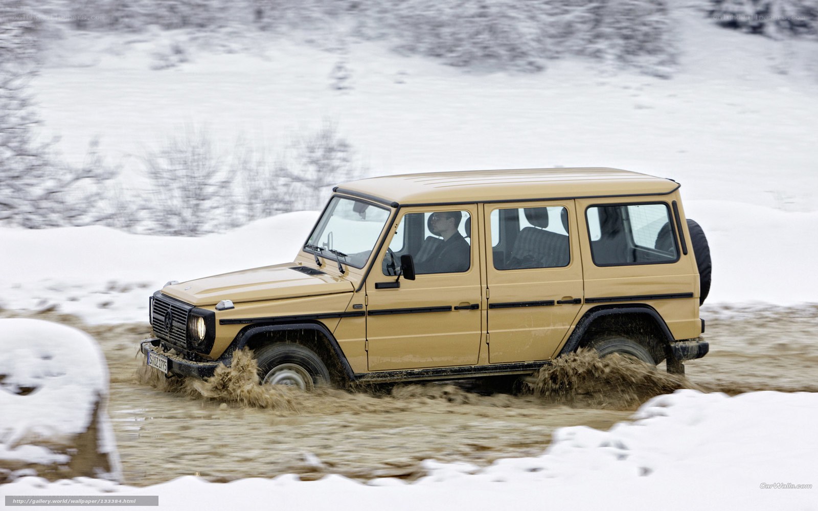 Beige SUV driving through mud