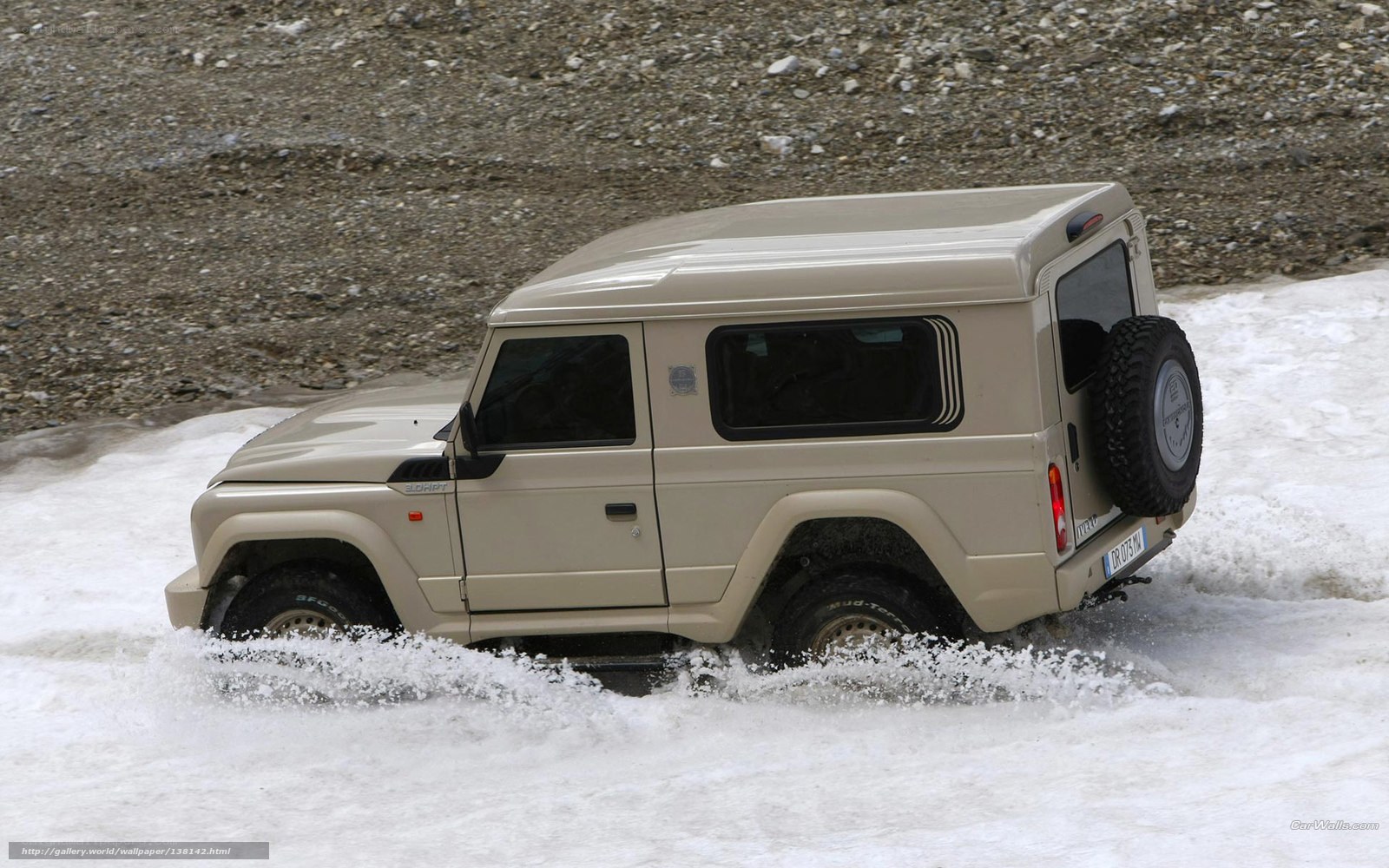 Beige SUV driving through snow