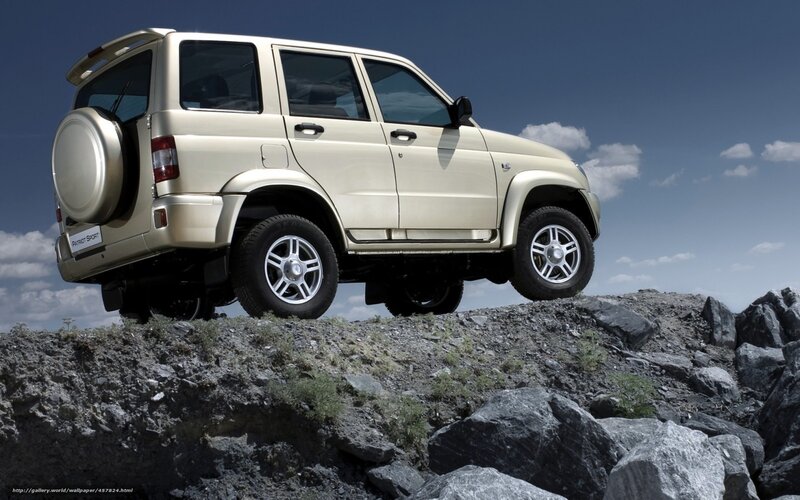 Beige SUV on Rocks