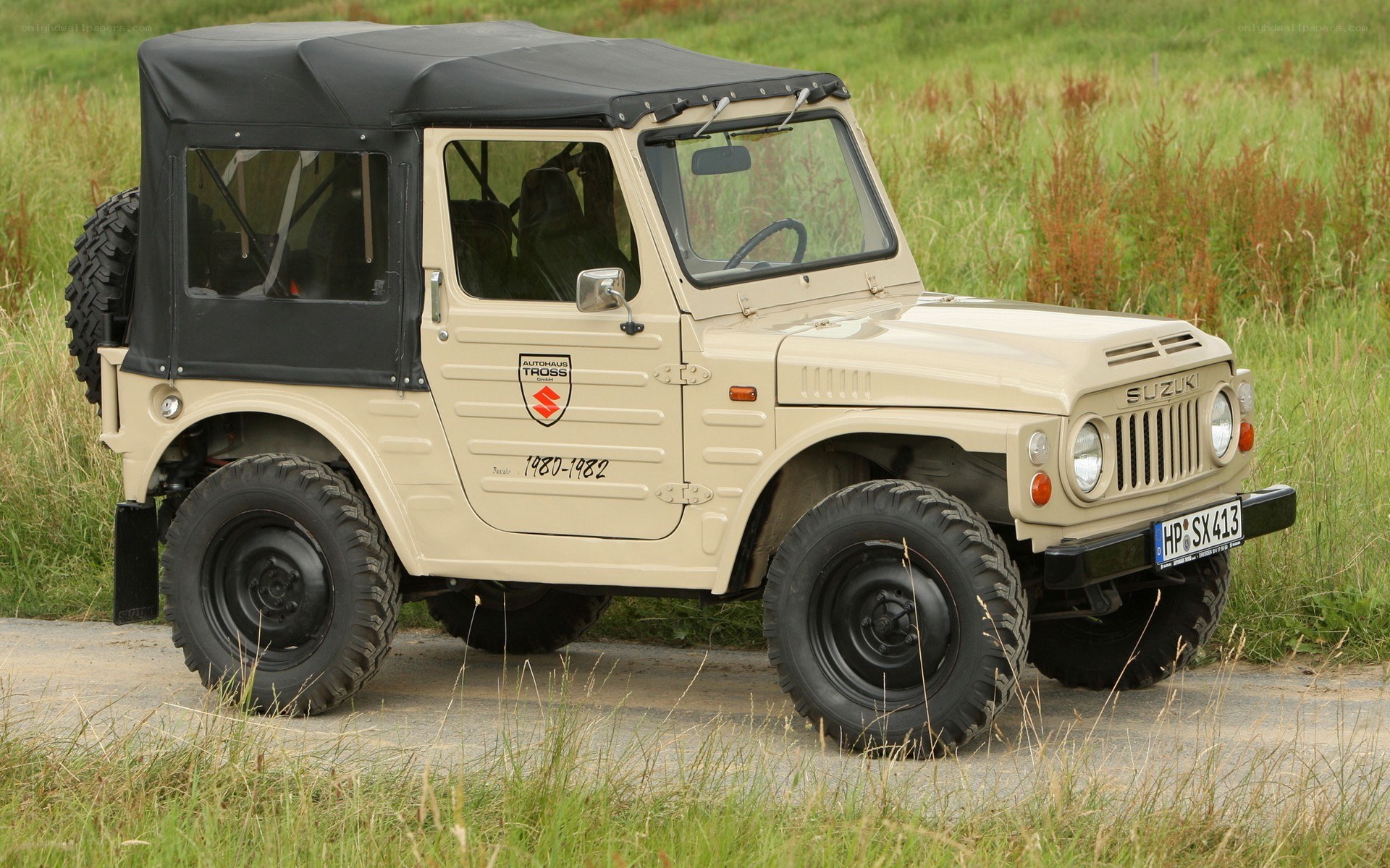 Beige Suzuki jeep in field