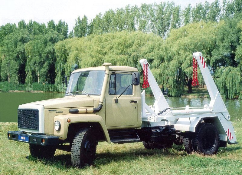 Beige truck with crane on grass