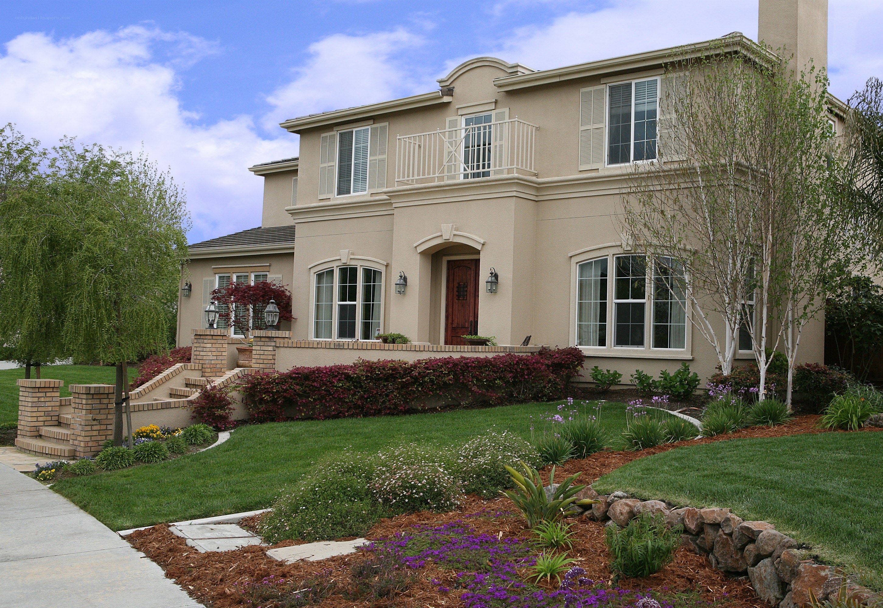 Beige two-story house with front yard
