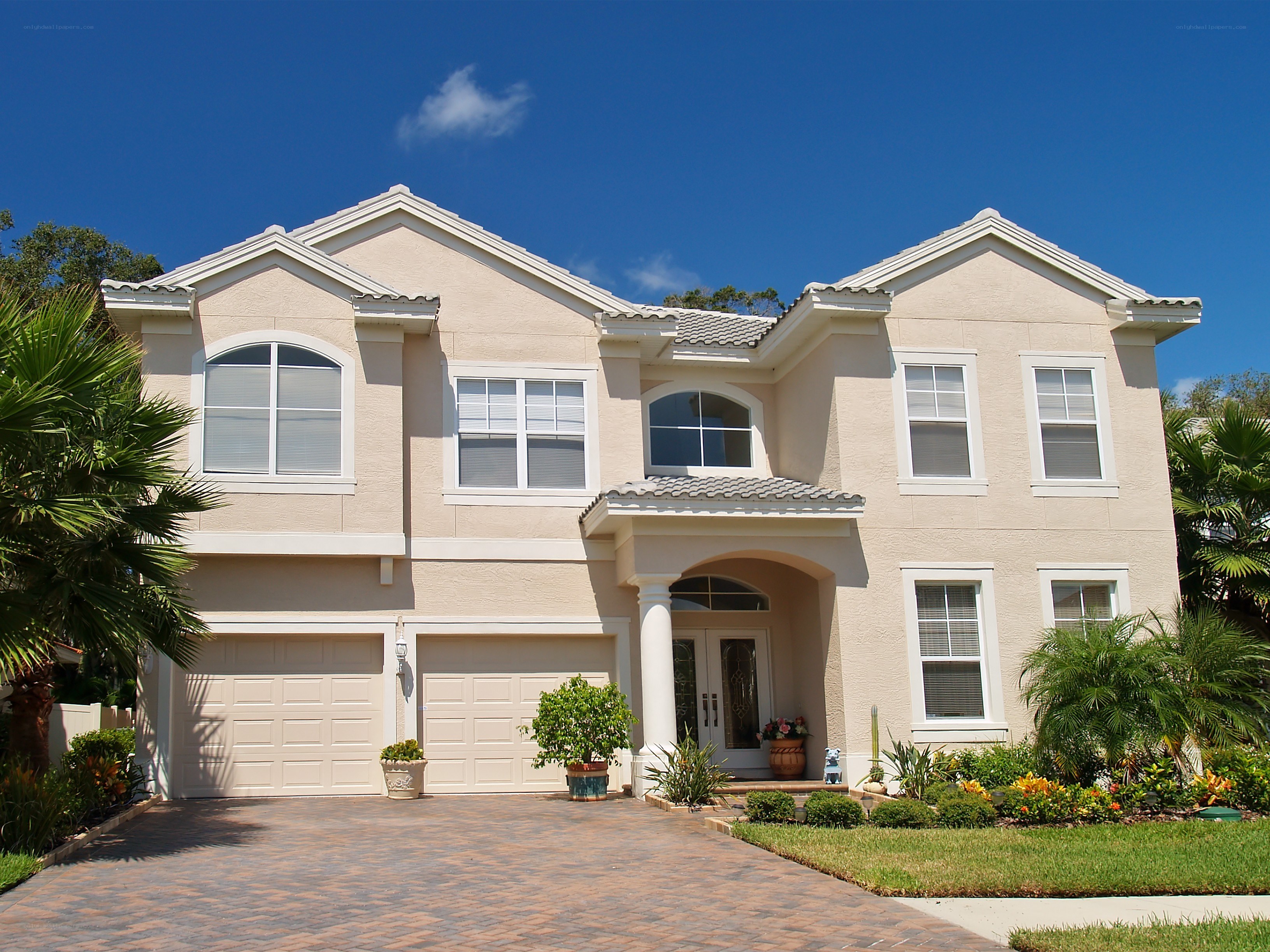 Beige two-story house with garage