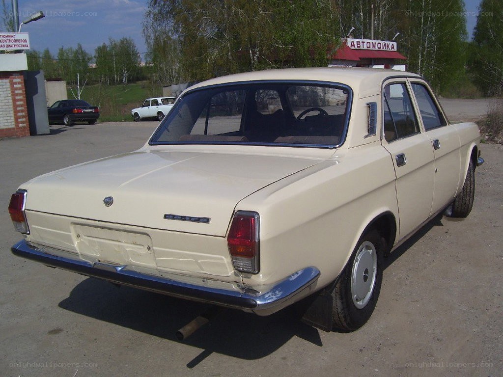 Beige vintage sedan parked outside