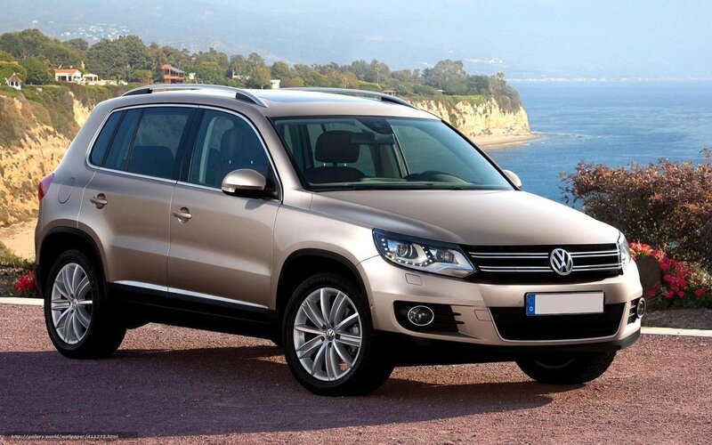 Beige Volkswagen Tiguan by the coast