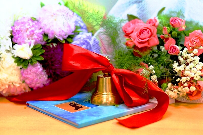 Bell on Book with Flowers
