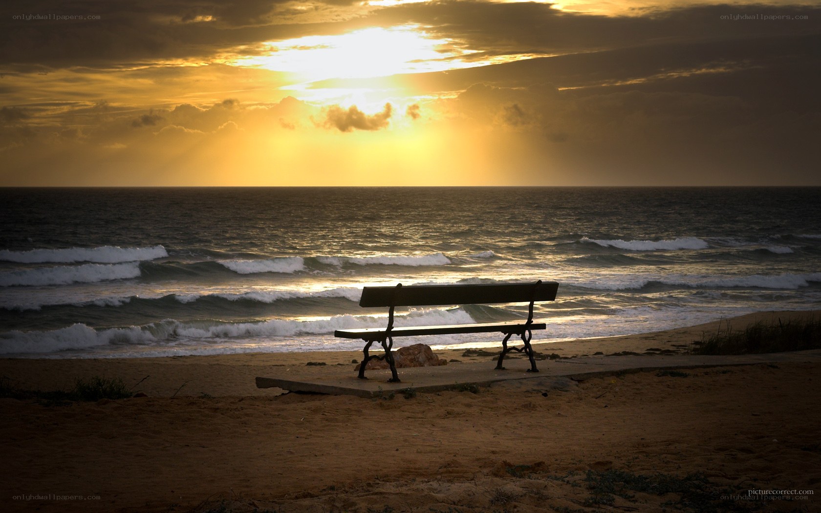 Bench at sunset by the sea