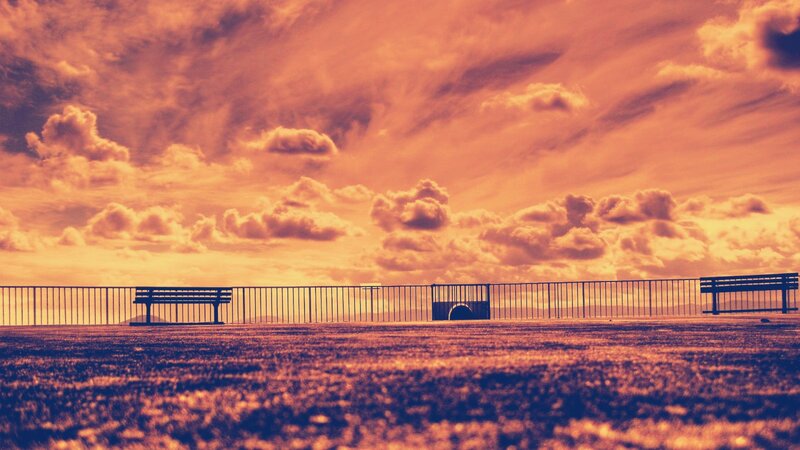Bench at sunset with dramatic sky