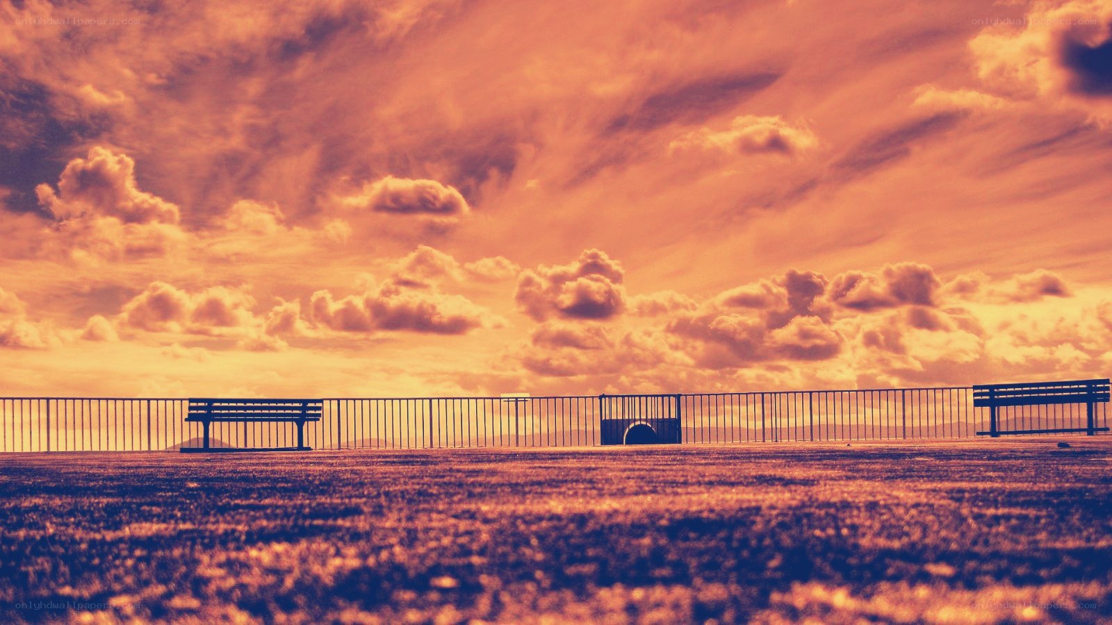 Bench at sunset with dramatic sky