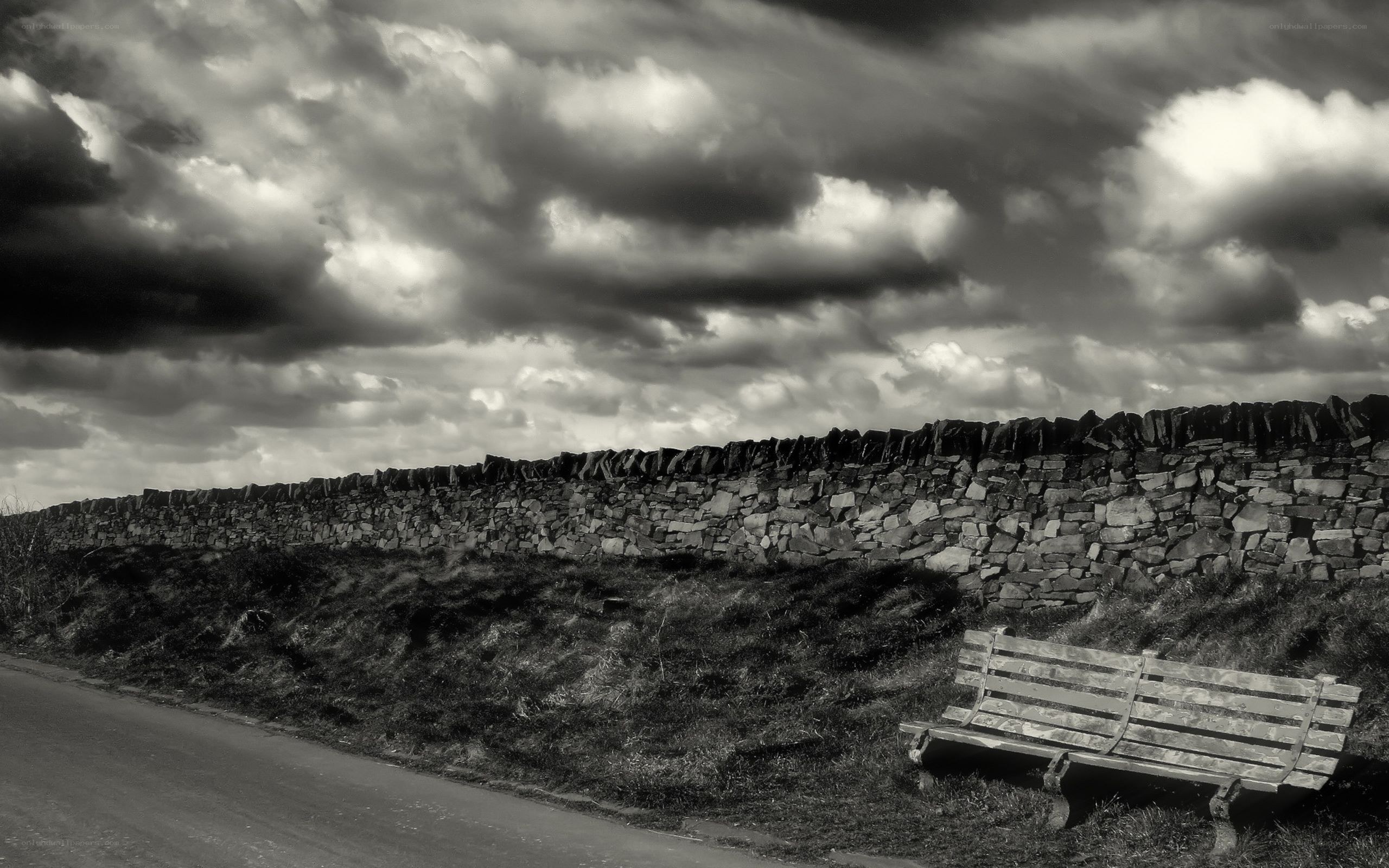 Bench beside stone wall