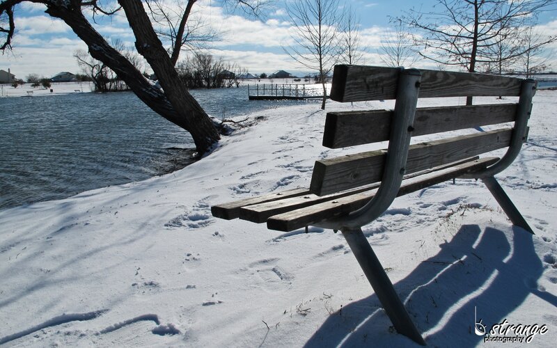 Bench by a snowy lake