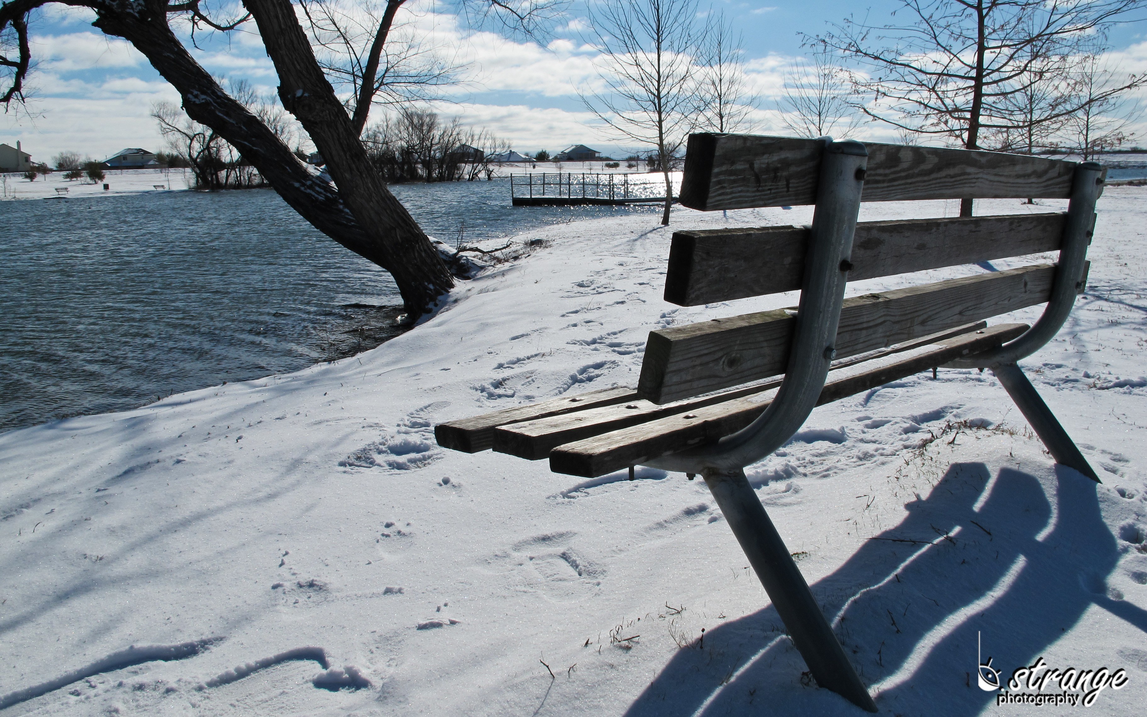 Bench by a snowy lake