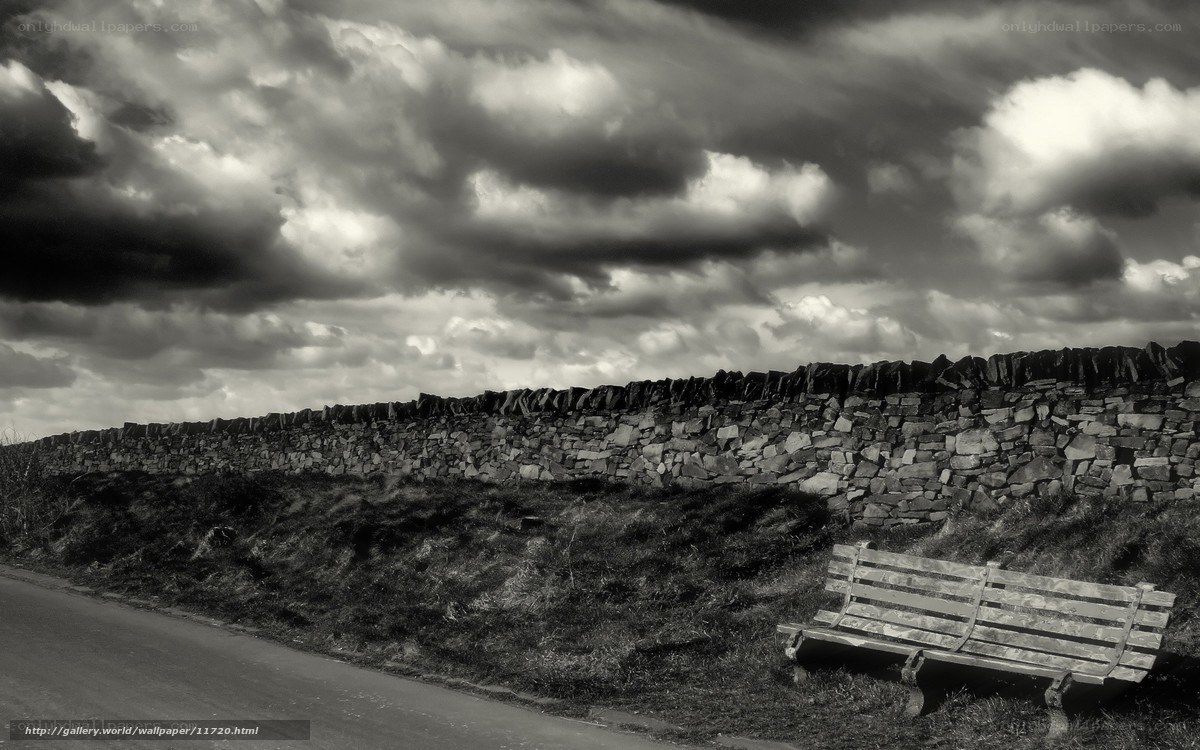Bench by stone wall