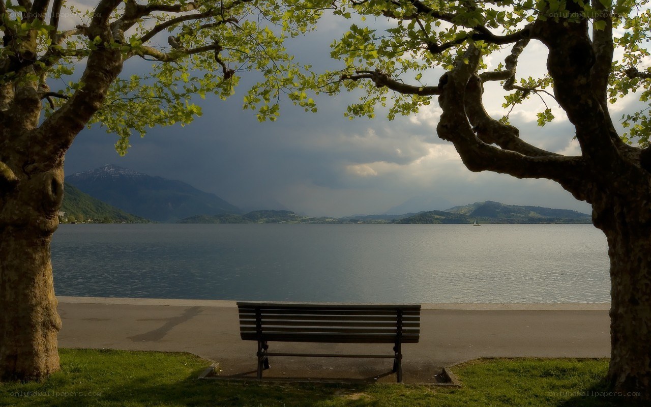 Bench by the lake with mountains