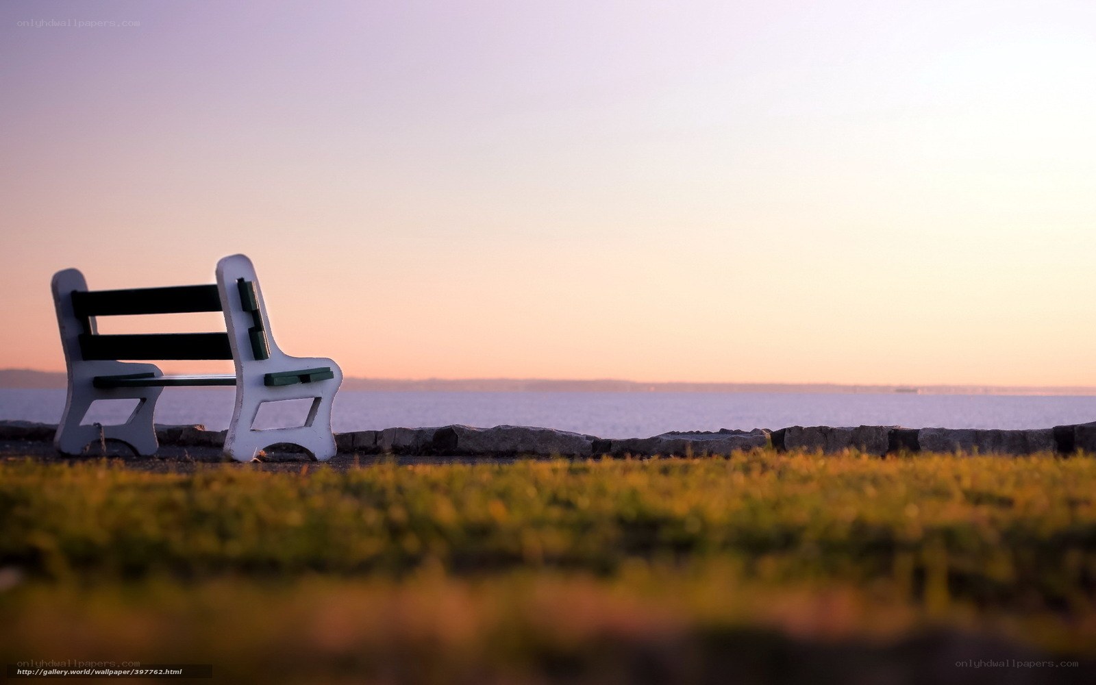Bench by the sea at sunset